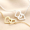 Interlocking Heart Charm Bracelet in Gold with Silver Version Also Available on Beige Fabric