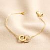 Interlocking Pearl and Crystal Hoops Bracelet in Gold on Beige Fabric