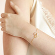 Model Wearing Interlocking Pearl and Crystal Hoops Bracelet in Gold