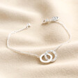 Interlocking Pearl and Crystal Hoops Bracelet in Silver on Beige Fabric