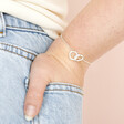 Model Wearing Interlocking Pearl and Crystal Hoops Bracelet in Silver With Hand In Pocket