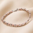 Stainless Steel Pink Vegan Leather Twisted Bracelet on Beige Fabric