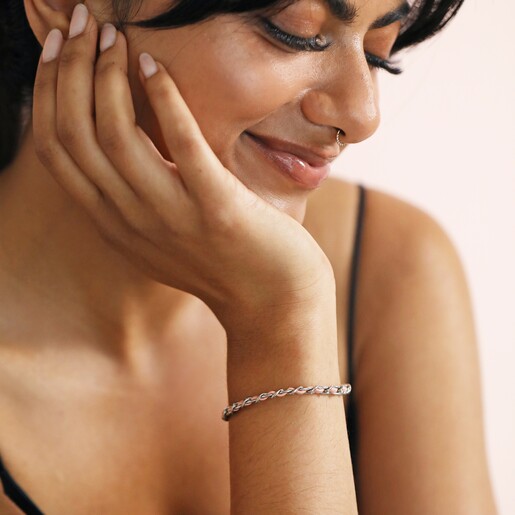 Model Cupping Chin Wearing Stainless Steel Pink Vegan Leather Twisted Bracelet 