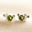 August Birthstone Cluster Stud Earrings in Silver laid on top of cream coloured material
