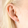 Close up of Blue Crystal Heart Huggie Hoop Earrings in Silver on model