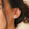Close up of brunette model wearing Blue Opal Dolphin Stud Earrings in Silver