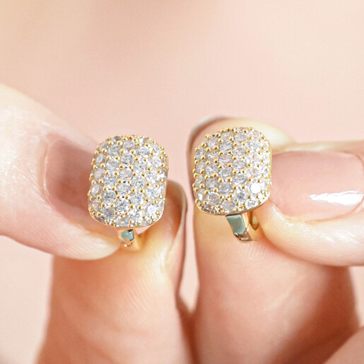 Model Holding Clear Crystal Pavé Square Huggie Hoop Earrings in Gold 