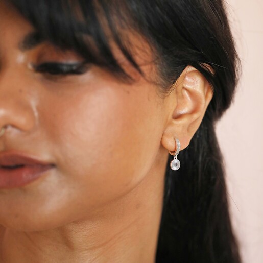 Moon and Sun Huggie Hoop Earrings in Silver on Model Looking to Side