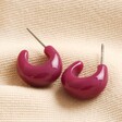 Purple Domed Resin Hoop Earrings on Beige Fabric