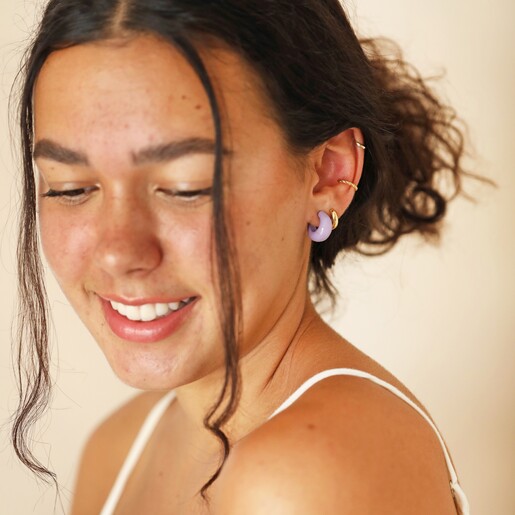 Purple Resin Domed Huggie Hoop Earrings on Model Looking Over Shoulder