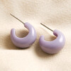 Purple Resin Domed Huggie Hoop Earrings on beige coloured material