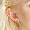 Close Up of Red Stone Heart Stud Earrings in Gold on Model