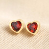 Red Stone Heart Stud Earrings in Gold on Beige Fabric