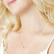 Model Wearing One of Birthstone Cluster Necklace in Gold