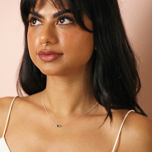 Model Looking Away Wearing May Birthstone Cluster Necklace in Silver