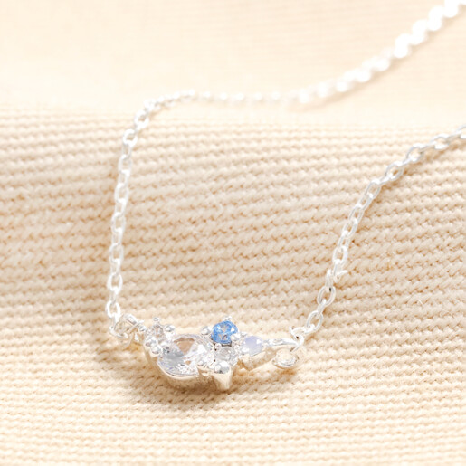April Birthstone Cluster Necklace in Silver on Beige Fabric