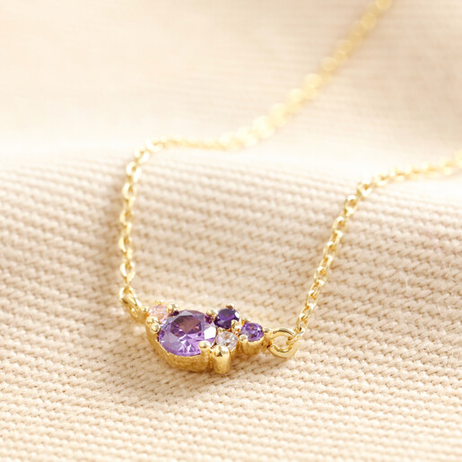 February Birthstone Cluster Necklace in Gold on Beige Fabric
