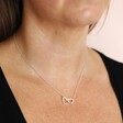 Model Wearing Interlocking Hearts Necklace in Silver