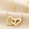 Interlocking Hearts Necklace in Gold on Beige Fabric