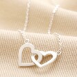 Interlocking Hearts Necklace in Silver on Beige Fabric