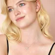 Model looking to side wearing Interlocking Pearl and Crystal Hoops Necklace in Silver