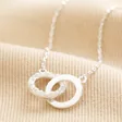Interlocking Pearl and Crystal Hoops Necklace in Silver on top of beige coloured material