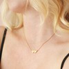 Close up of Linked Hearts Pendant Necklace in Gold on Model
