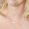 Close Up of Model Wearing Linked Hearts Pendant Necklace in Silver