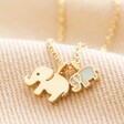 Mum and Baby Elephant Charm Necklace in Gold on Beige Fabric