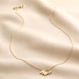 Full Chain of Mum and Baby Elephant Charm Necklace in Gold on Beige Fabric