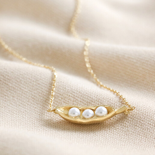 Pearl Three Peas in a Pod Pendant Necklace in Gold on Beige Fabric