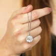 Model holding Personalised Stainless Steel Zodiac Pendant Necklace over knuckles
