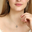 Stainless Steel Cancer Pendant Necklace on Model Holding Necklace Up To Camera 