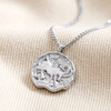 Stainless Steel Capricorn Pendant Necklace on Beige Fabric