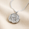 Stainless Steel Gemini Pendant Necklace on Beige Fabric
