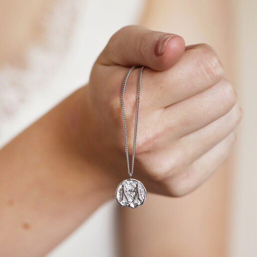 Stainless Steel Gemini Pendant Necklace Held in Model's Hand