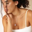 Brunette model wearing the Stainless Steel Sagittarius Pendant Necklace white white top