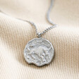Stainless Steel Taurus Pendant Necklace on Beige Fabric