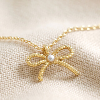 Tiny Pearl Bow Pendant Necklace in Gold