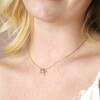 Tiny Pearl Bow Pendant Necklace in Gold Close Up on Model
