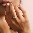 Model with hand up to mouth wearing Crystal Teardrop Ring in Sterling Silver