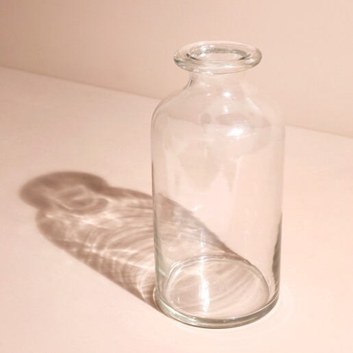 Slim Glass Flower Vase on Beige Surface with Shadow