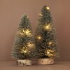 Small Light Up LED Tree Ornament with large tree ornament against natural background