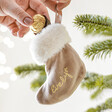 Personalised Mini Velvet Stocking Hanging Decoration Hnaging in Tree with Model Putting Chocolate Inside