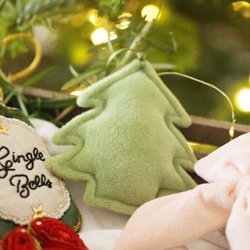 Plush Green Christmas Tree Hanging Decoration amongst other velvet decorations in wooden tray