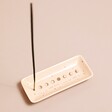Celestial Incense Holder with incense stick inside against neutral coloured background