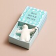 Tiny Matchbox Ceramic Bear Token with box open on plain pink surface