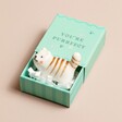 Tiny Matchbox Ceramic Cat Token on plain pink surface