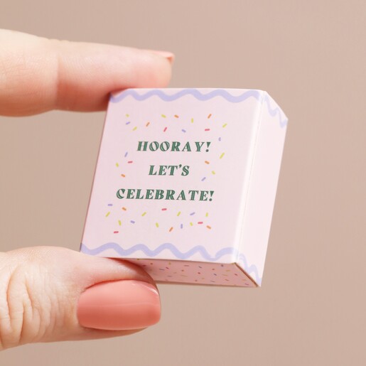 Model Holding Box Model holding the Tiny Matchbox Ceramic Champagne Token packaging between fingers