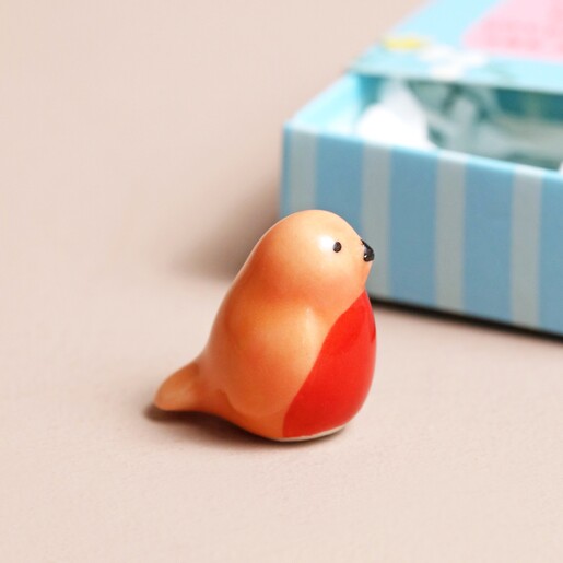 Close Up of Robin Robin token standing outside of the Tiny Matchbox Ceramic Robin Token packaging